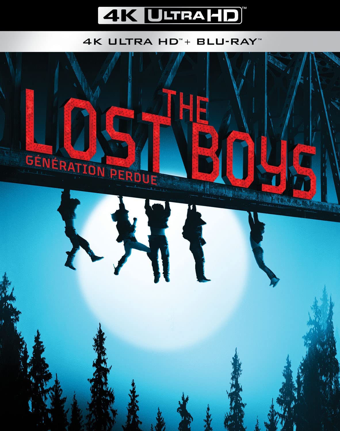 Framed by a full moon, five teenagers hang from a railroad trestle in the cover art for Warner's 4K edition of THE LOST BOYS.