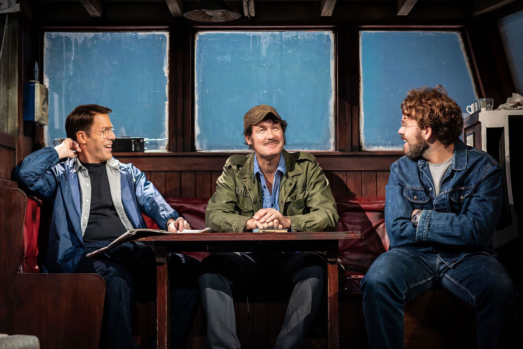 Demetri Goritsas, Ian Shaw and Liam Murray Scott sit around the Orca's table in THE SHARK IS BROKEN.