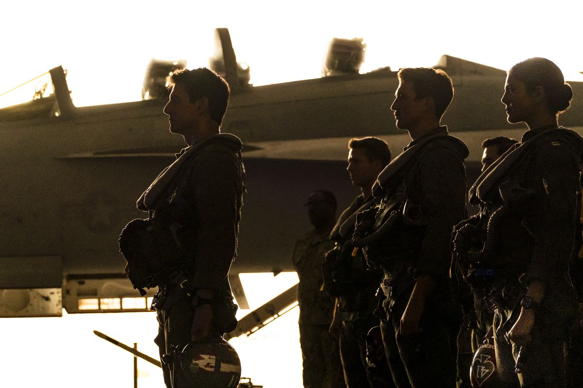 Tom Cruise, Miles Teller,  Monica Barbaro and friends stand tall on the flight deck in TOP GUN: MAVERICK.