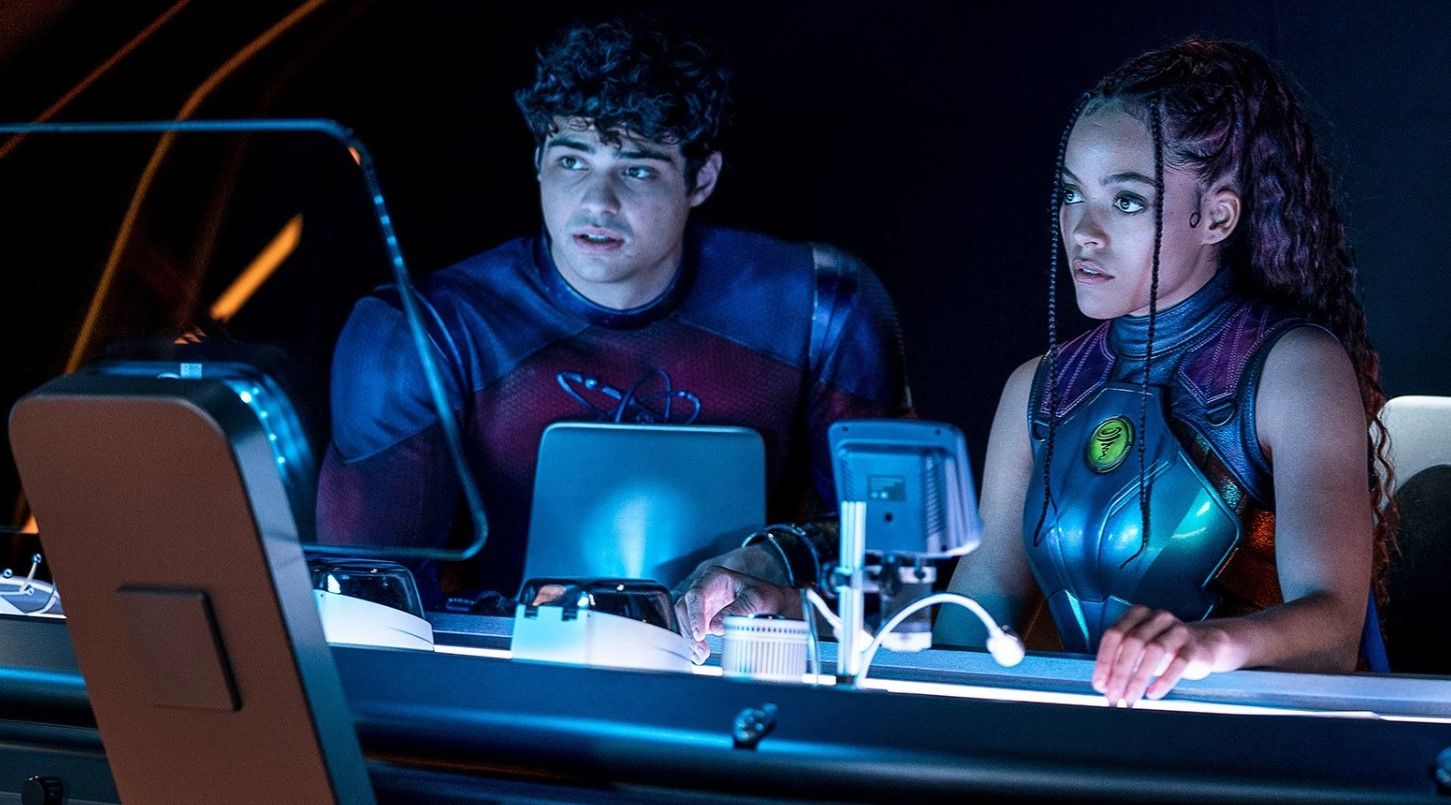 Atom Smasher (Noah Centineo) and Cyclone (Quintella Swindell) sit around looking concerned in a still from BLACK ADAM. 