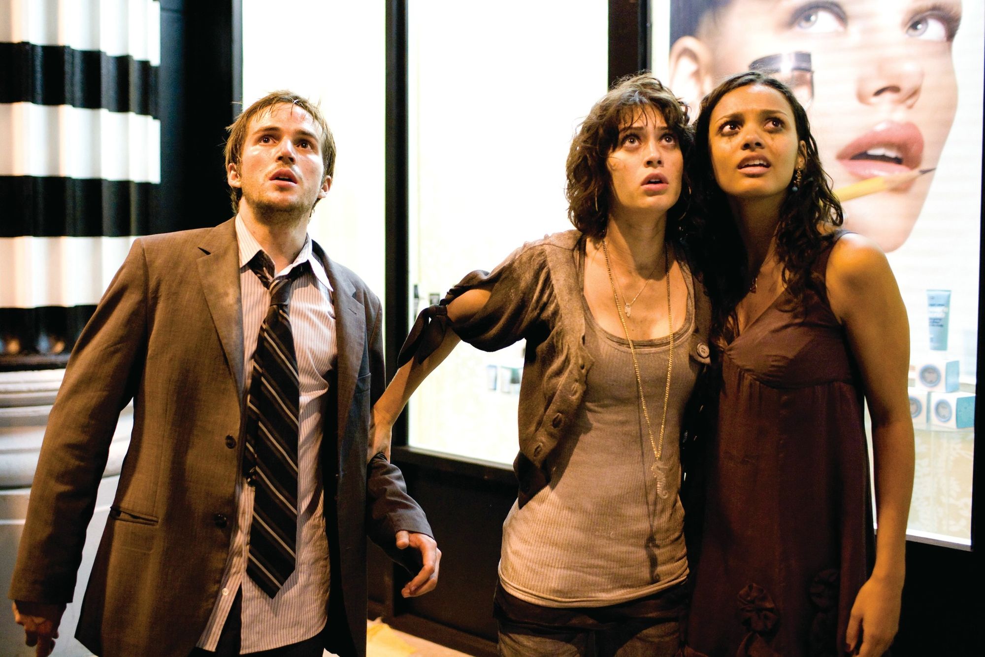 Michael Stahl-David, Lizzy Caplan and Jessica Lucas survey the skyline in a still from CLOVERFIELD.