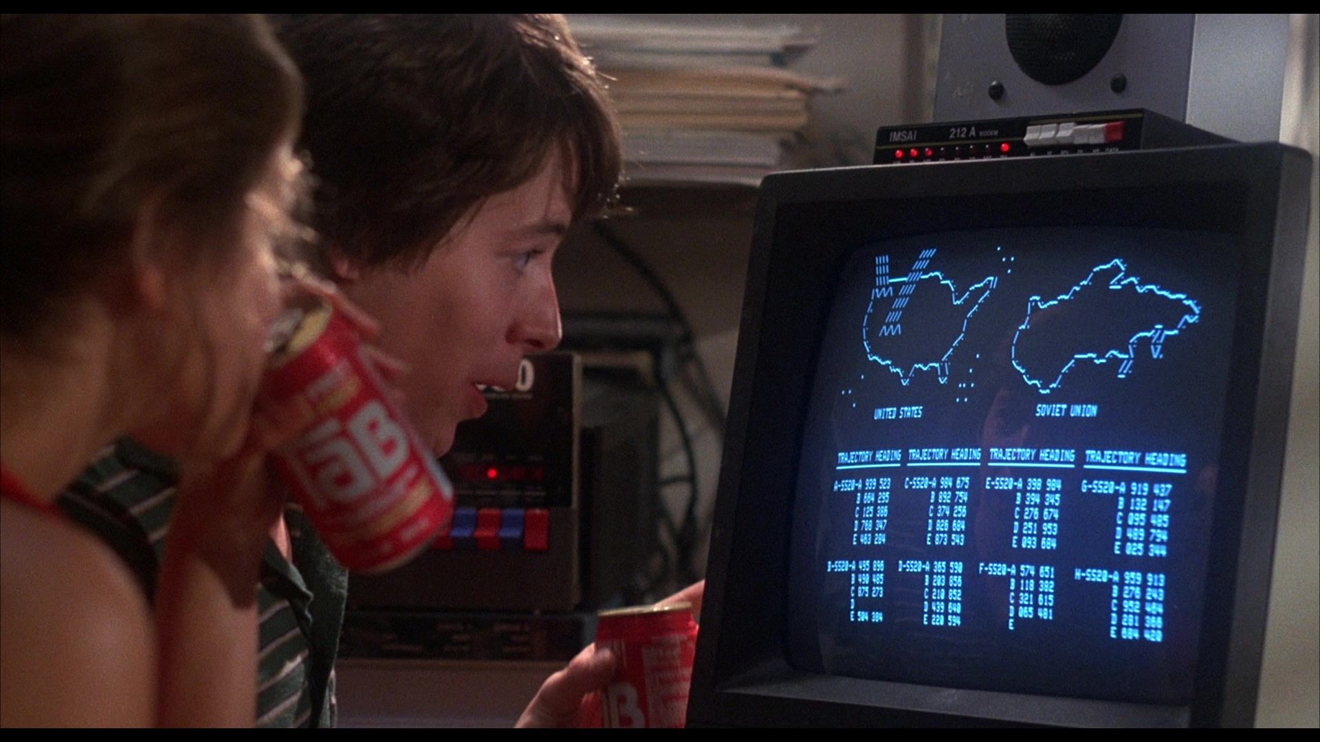 Ally Sheedy and Matthew Broderick slam Tab cola and game out the end of the world in a still from WARGAMES.