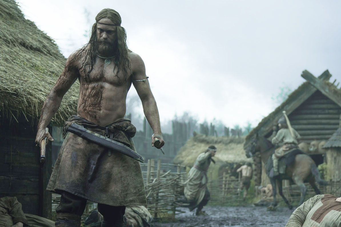 An image of Alexander Skarsgard, shirtless and covered in the blood of his enemies, in THE NORTHMAN.
