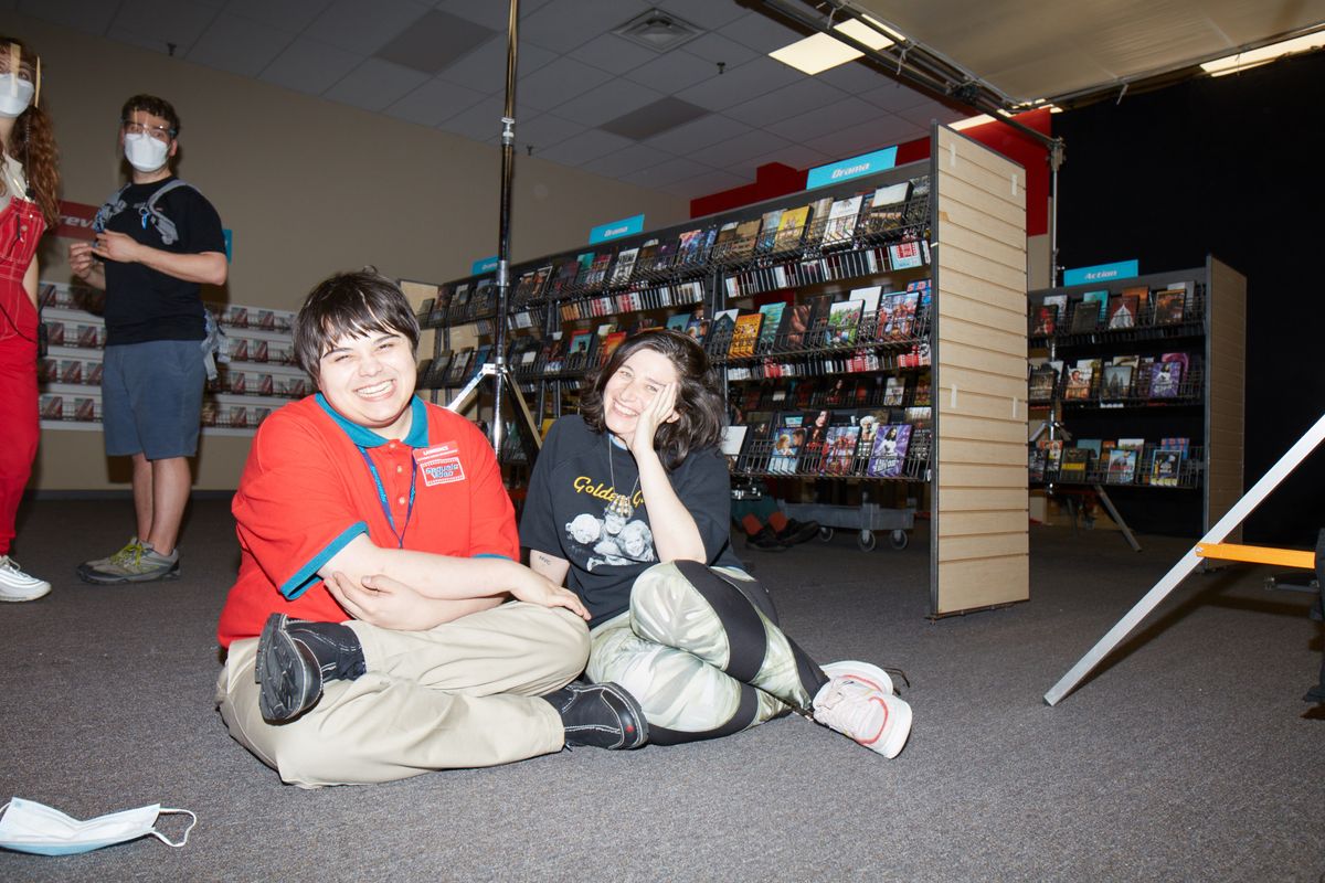 Actor Isaiah Lehtinen and director Chandler Levack on the set of I LIKE MOVIES' re-created video store.