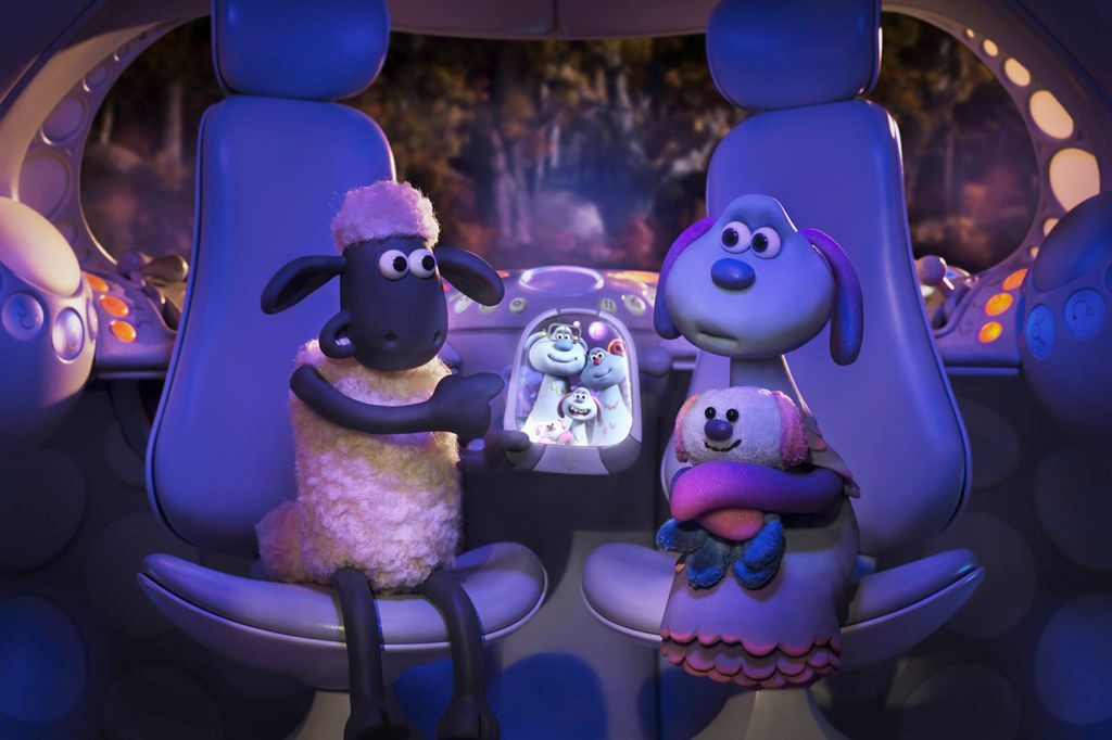 Shaun the Sheep and his alien pal Lu-la sit in her spaceship with a picture of her family in FARMAGEDDON.