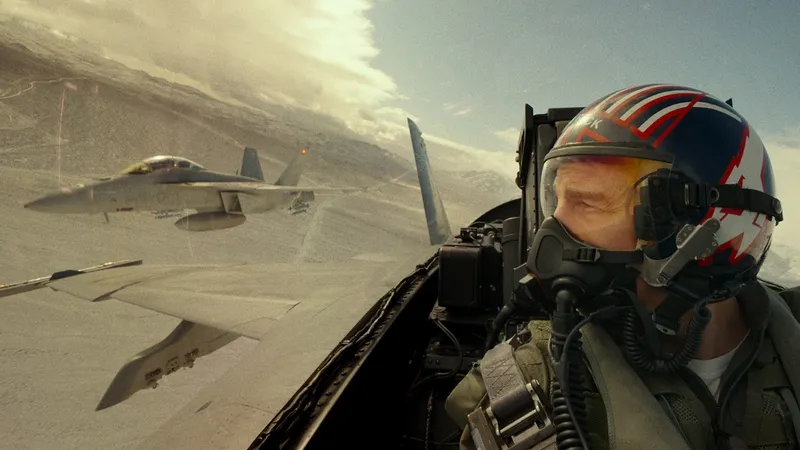 For real: Tom Cruise glances out of a fighter jet's cockpit in a still from TOP GUN: MAVERICK. 