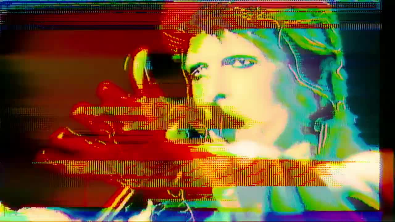 An image from MOONAGE DAYDREAM depicts a super-saturated David Bowie in performance.