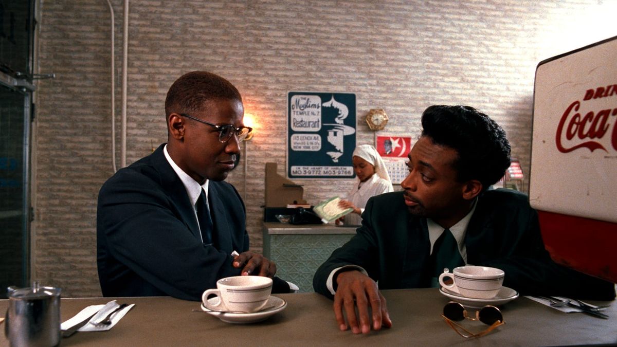 Denzel Washington and Spike Lee strategize over coffee in a scene from Lee's MALCOLM X.