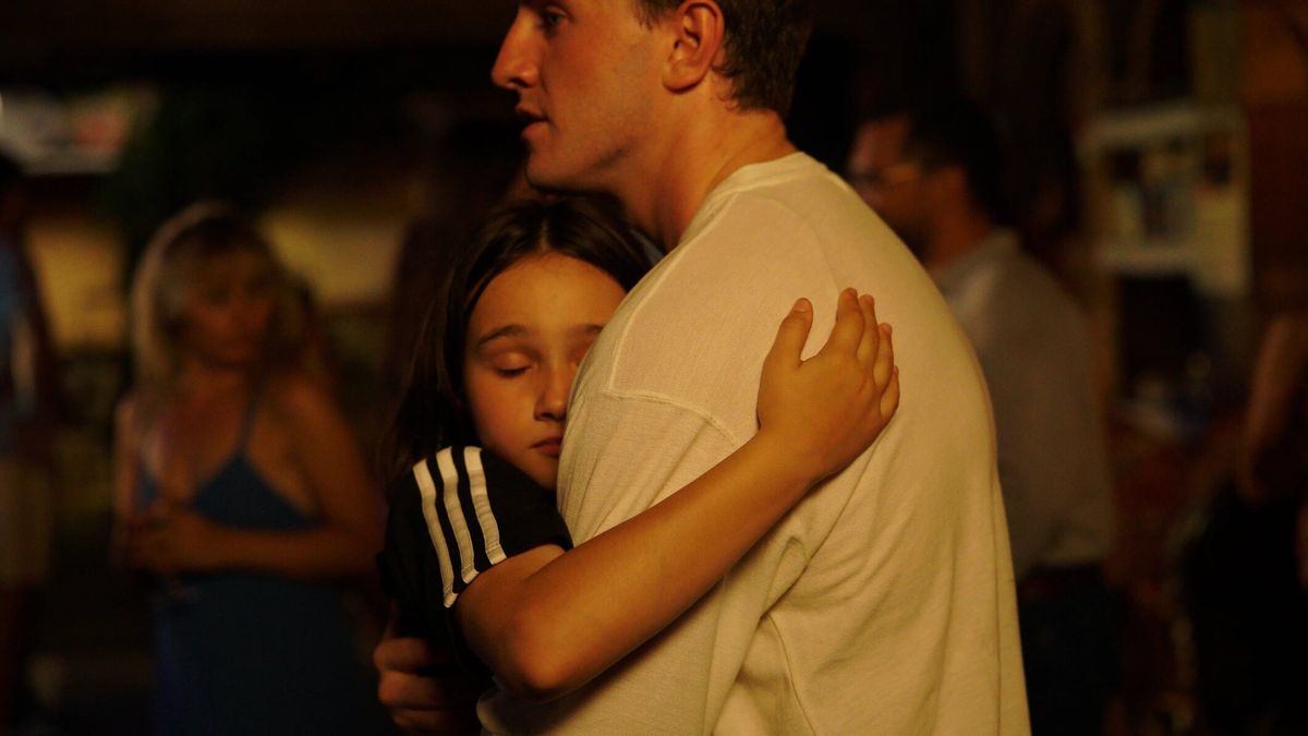 Frankie Corio hugs Paul Mescal, possibly for dear life, in a still from Charlotte Wells' AFTERSUN.